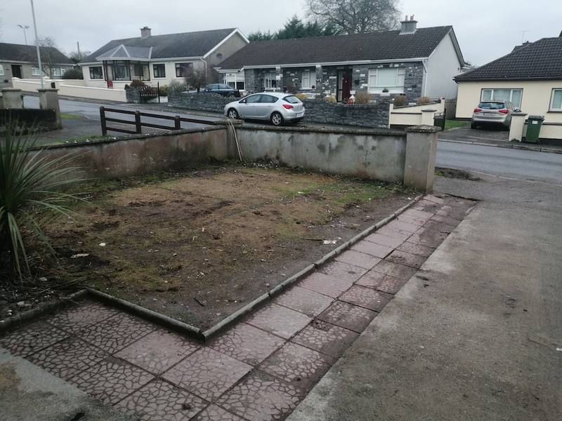 The front garden in Ardnore before the work, grass and a paved path
