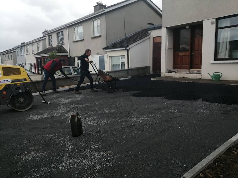 Ardnore: two of the crew raking tarmac to the kerbs