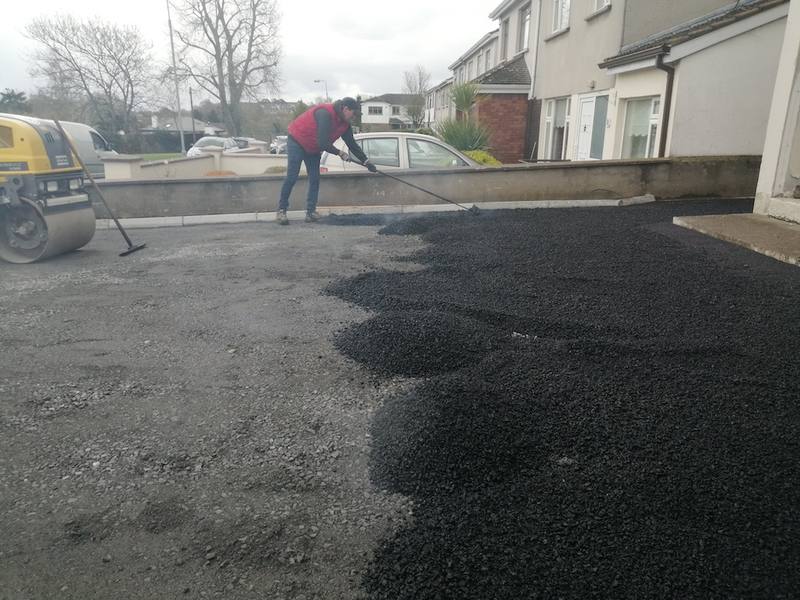 Ardnore: raking the tarmac level, roller waiting