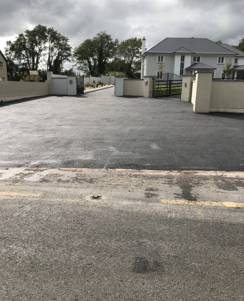 New tarmac at a gated entrance, joined to the public road