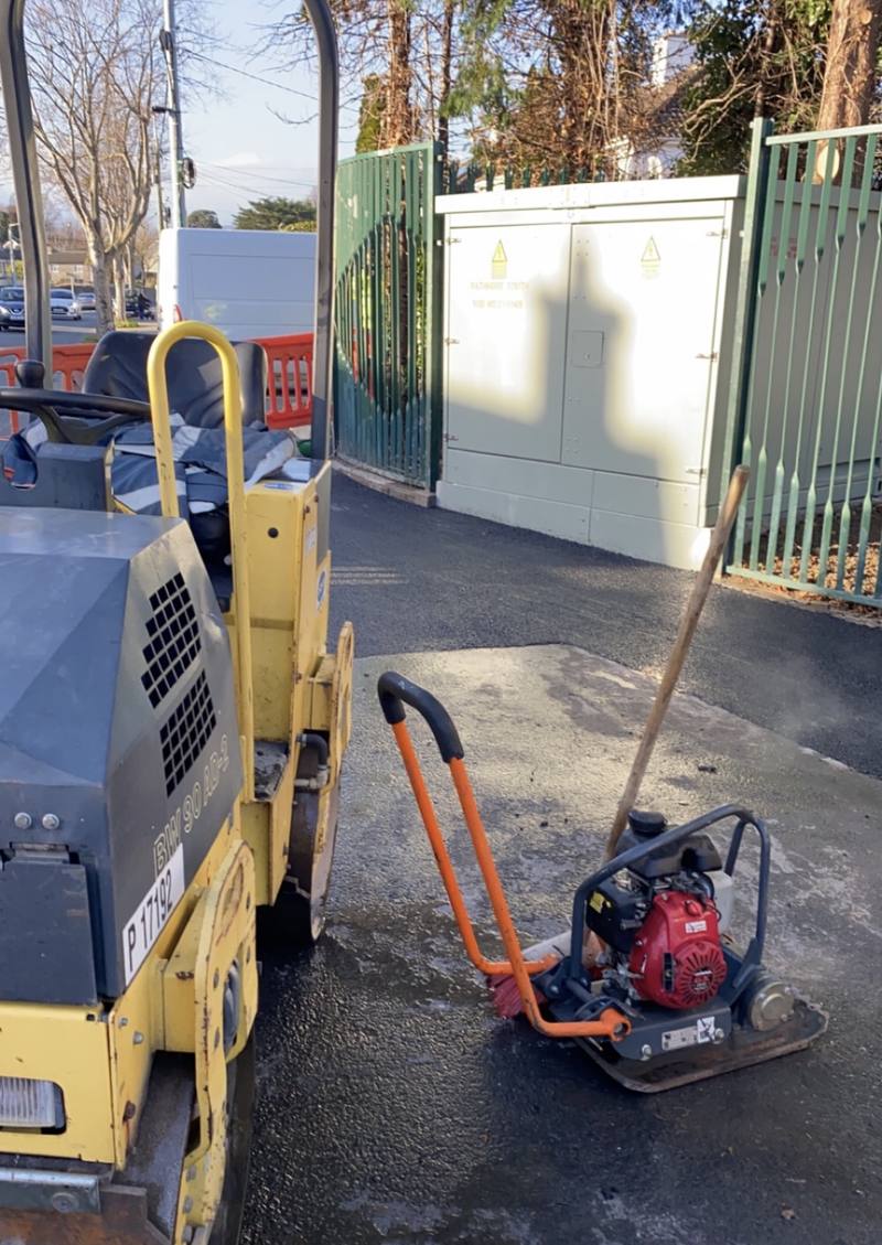The roller and plate compactor on a finished patch at a gateway