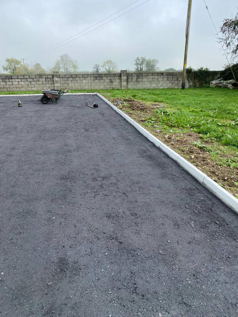 A new kerbed tarmac driveway in the country