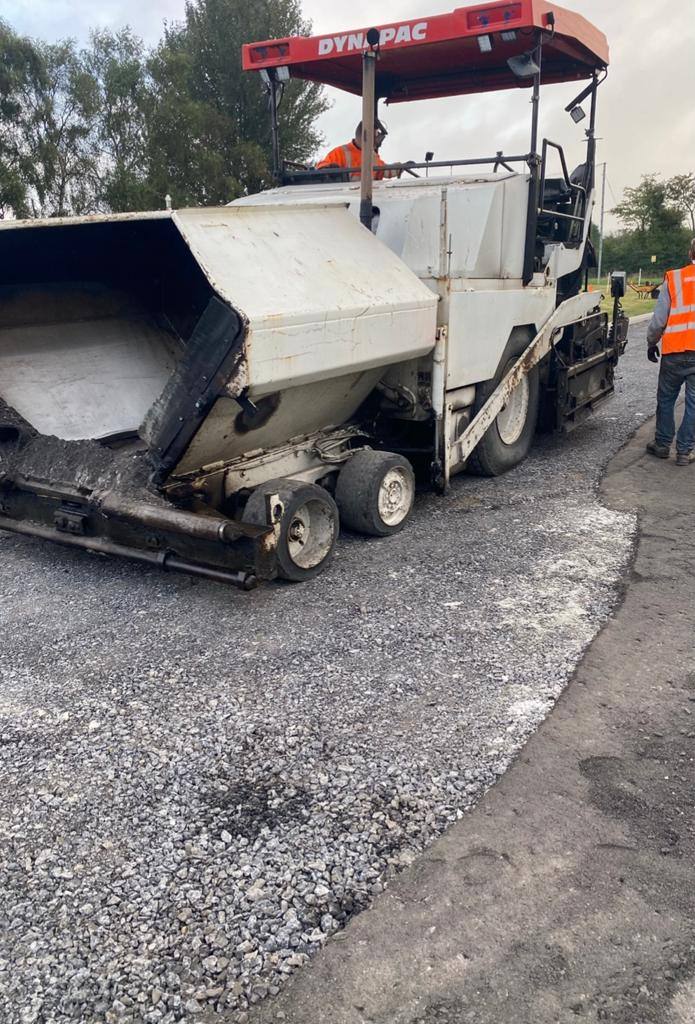The paver laying tarmac onto a stone base