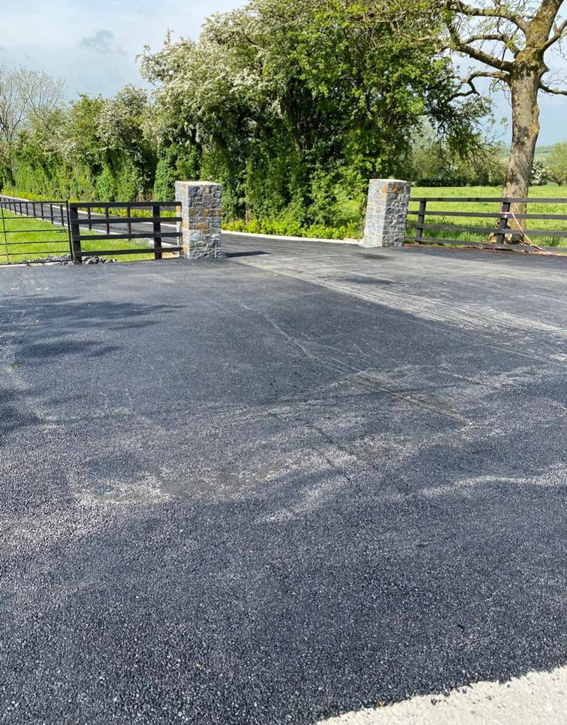 New tarmac inside an entrance with stone piers